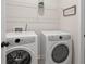 Charming laundry room features modern appliances and a 