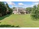 Expansive backyard of a two-story home, surrounded by trees and fencing at 207 Breckenridge Ct, Canton, GA 30115