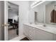 Bright bathroom featuring double vanity, ample counter space, and an open doorway to an office at 207 Breckenridge Ct, Canton, GA 30115