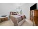Cozy bedroom with a comfortable bed, corner window, and a cabinet with a wall-mounted TV at 207 Breckenridge Ct, Canton, GA 30115