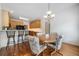 Charming dining area with hardwood floors, stylish chandelier, and convenient bar seating in the background at 207 Breckenridge Ct, Canton, GA 30115