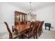 Spacious dining room featuring a large wooden table set for eight, beneath a decorative chandelier at 207 Breckenridge Ct, Canton, GA 30115