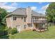 Back exterior of a two-story home featuring a deck and a well-maintained lawn at 207 Breckenridge Ct, Canton, GA 30115