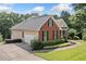 Image of a charming home with brick and siding, features a two-car garage and meticulously maintained lawn at 207 Breckenridge Ct, Canton, GA 30115