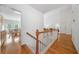 Bright hallway with hardwood floors and white banisters leading to various rooms at 207 Breckenridge Ct, Canton, GA 30115