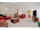 Open-concept living room featuring vaulted ceilings, neutral carpet, and inviting seating areas at 207 Breckenridge Ct, Canton, GA 30115