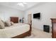 Spacious main bedroom featuring a ceiling fan, mounted TV, and neutral color palette at 207 Breckenridge Ct, Canton, GA 30115