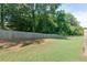 Backyard view featuring a privacy fence and green grass at 3016 Creekside Overlook Way, Austell, GA 30168