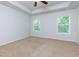 A carpeted bedroom with white trim and natural light from the windows at 3016 Creekside Overlook Way, Austell, GA 30168