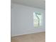 This bedroom features neutral carpet, white walls, and a window for natural light at 3016 Creekside Overlook Way, Austell, GA 30168