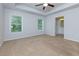 A carpeted primary bedroom with white trim and natural light from the windows and en suite bath at 3016 Creekside Overlook Way, Austell, GA 30168