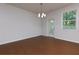 Dining room with hardwood floors, a modern chandelier, and a large window at 3016 Creekside Overlook Way, Austell, GA 30168