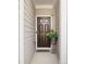 Welcoming front entry featuring a dark wood door and a potted plant on a stand at 3016 Creekside Overlook Way, Austell, GA 30168