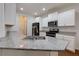 Kitchen with granite countertops, sleek stainless steel appliances, and white cabinetry at 3016 Creekside Overlook Way, Austell, GA 30168