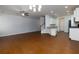 Open living room features hardwood floors, a ceiling fan, and a neutral color palette at 3016 Creekside Overlook Way, Austell, GA 30168