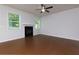 Bright living room with a cozy fireplace, ceiling fan, and large windows at 3016 Creekside Overlook Way, Austell, GA 30168