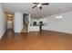 Open-concept living space with a modern staircase, wood floors, and a view of the kitchen at 3016 Creekside Overlook Way, Austell, GA 30168
