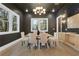 Elegant dining room features a modern chandelier and beautiful views from large windows at 2497 Wawona Dr, Brookhaven, GA 30319