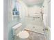 Bright bathroom with a walk-in shower featuring grab bars and a window providing natural light at 2251 Stag Run Run, Suwanee, GA 30024