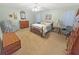 Spacious bedroom featuring a bed, dresser, and large window for natural light at 2251 Stag Run Run, Suwanee, GA 30024