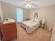 Cozy bedroom with a patterned bed, side table, and dresser, creating a comfortable and inviting space at 2251 Stag Run Run, Suwanee, GA 30024