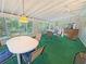 Bright sunroom with multiple windows, table and chairs, a ceiling fan, and outdoor views, perfect for relaxation at 2251 Stag Run Run, Suwanee, GA 30024