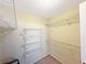 Spacious walk-in closet featuring white wire shelving and ample storage space for organizing clothes and accessories at 2251 Stag Run Run, Suwanee, GA 30024