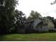 The backyard featuring a spacious porch, deck, and lush green lawn at 5523 Bahia Mar Cir, Stone Mountain, GA 30087