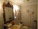 Charming bathroom with a decorative mirror, ornate sconces, and patterned wallpaper at 5523 Bahia Mar Cir, Stone Mountain, GA 30087