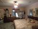 Cozy bedroom with a ceiling fan, large bed, lots of display areas and traditional furnishings at 5523 Bahia Mar Cir, Stone Mountain, GA 30087