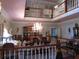Elegant dining room with a chandelier, decorative china cabinet, and a view from the second story landing at 5523 Bahia Mar Cir, Stone Mountain, GA 30087