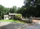 Charming home featuring a well-manicured lawn, mature trees, and a quaint white facade at 5523 Bahia Mar Cir, Stone Mountain, GA 30087