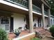 Inviting front porch with brick flooring, decorative columns, and charming curb appeal at 5523 Bahia Mar Cir, Stone Mountain, GA 30087
