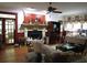 Cozy living room with a fireplace, wood floors, and natural light from large windows at 5523 Bahia Mar Cir, Stone Mountain, GA 30087