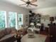 Comfortable living room featuring large windows with outdoor views, a ceiling fan and wood floors at 5523 Bahia Mar Cir, Stone Mountain, GA 30087
