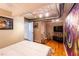 Bright bedroom featuring a modern bed, hardwood floors, and an eye-catching abstract art piece at 10 James St # 11B, Hampton, GA 30228