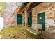 Charming courtyard with a wooden swing, brick walls and door entrances to property at 10 James St # 11B, Hampton, GA 30228