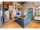 Bright living room with exposed brick, modern furniture, vibrant art, and a unique swing feature at 10 James St # 11B, Hampton, GA 30228