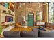 Cozy living room features exposed brick, modern art, and a bright eclectic-painted door at 10 James St # 11B, Hampton, GA 30228