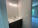 Modern bathroom with a granite vanity, stylish lighting, and an open door to a bedroom at 1005 Liberty Springs Dr, Woodstock, GA 30188