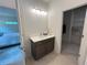Modern bathroom featuring a vanity with quartz countertop, stylish light fixture and next to a walk-in closet at 1005 Liberty Springs Dr, Woodstock, GA 30188