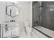Modern bathroom with vanity, a glass-enclosed shower and bathtub combo, and stylish herringbone tile at 1740 S Gordon Sw St, Atlanta, GA 30310