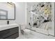 Modern bathroom with elegant marble wall surround and glass shower door over a soaking tub at 1740 S Gordon Sw St, Atlanta, GA 30310