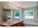 Spacious bathroom showcases a double sink vanity and a separate tub and glass door shower at 180 Jay Trl, Fayetteville, GA 30215