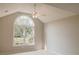 Light-filled bedroom features a large window, vaulted ceiling and ceiling fan at 180 Jay Trl, Fayetteville, GA 30215