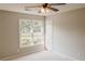 Bedroom with neutral paint and a window facing the yard at 180 Jay Trl, Fayetteville, GA 30215
