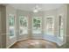 Bright breakfast nook area with hardwood floors surrounded by windows with natural light at 180 Jay Trl, Fayetteville, GA 30215