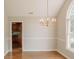 Dining room featuring hardwood floors, chair rail, and a hanging chandelier at 180 Jay Trl, Fayetteville, GA 30215