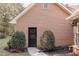 Brick house exterior with a black door, complemented by shrubbery and manicured mulch beds at 180 Jay Trl, Fayetteville, GA 30215