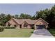 Charming brick home with a well-manicured lawn and a two-car garage at 180 Jay Trl, Fayetteville, GA 30215